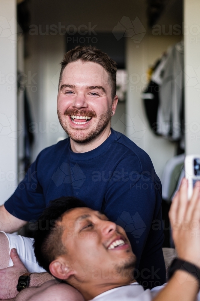 happy couple hanging out at home - Australian Stock Image