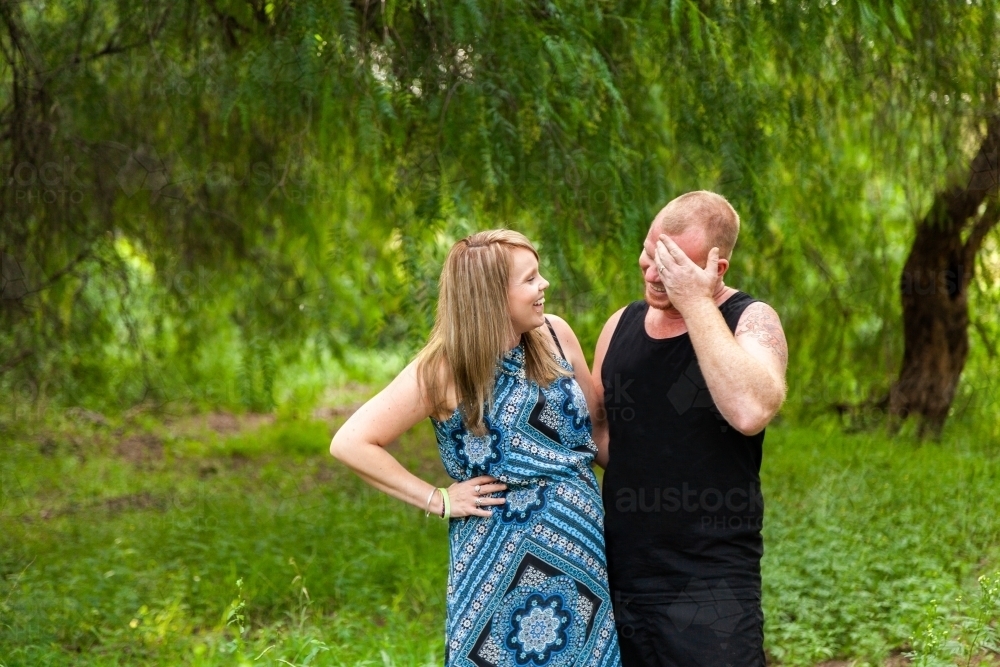 Happy couple laughing together - Australian Stock Image