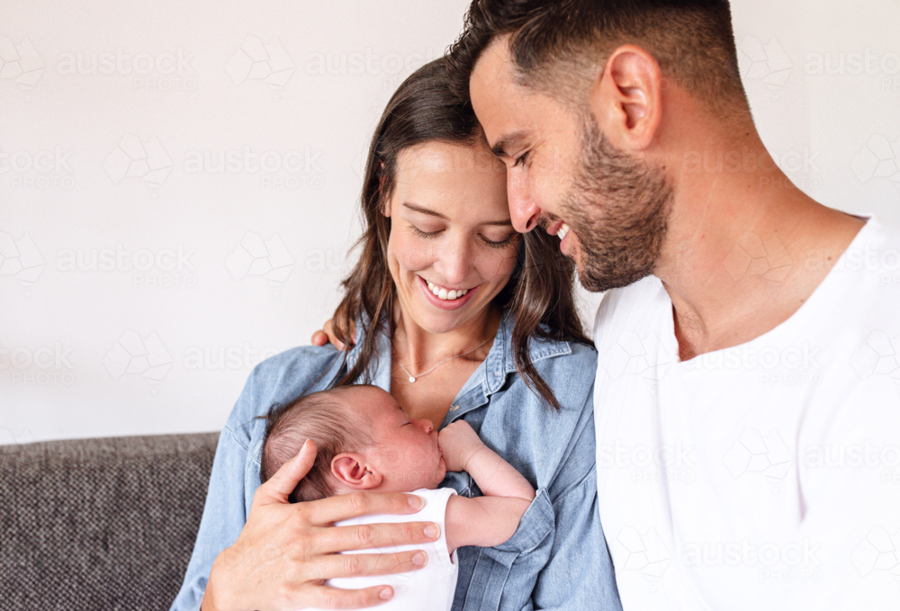 Happy couple looking at their newborn baby boy - Australian Stock Image