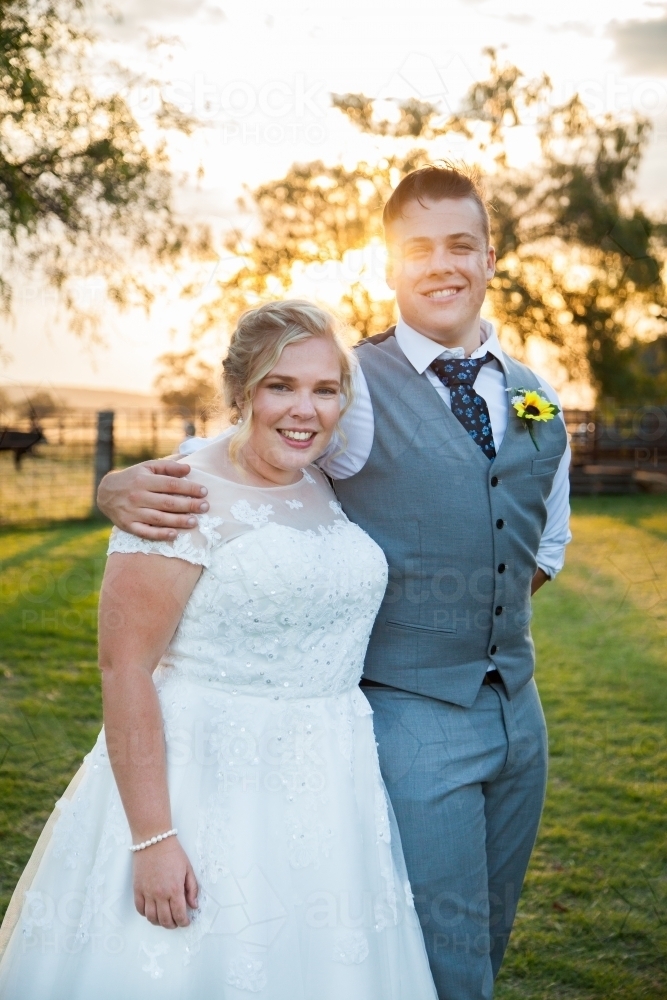 Happy couple on their wedding day at sunset - Australian Stock Image