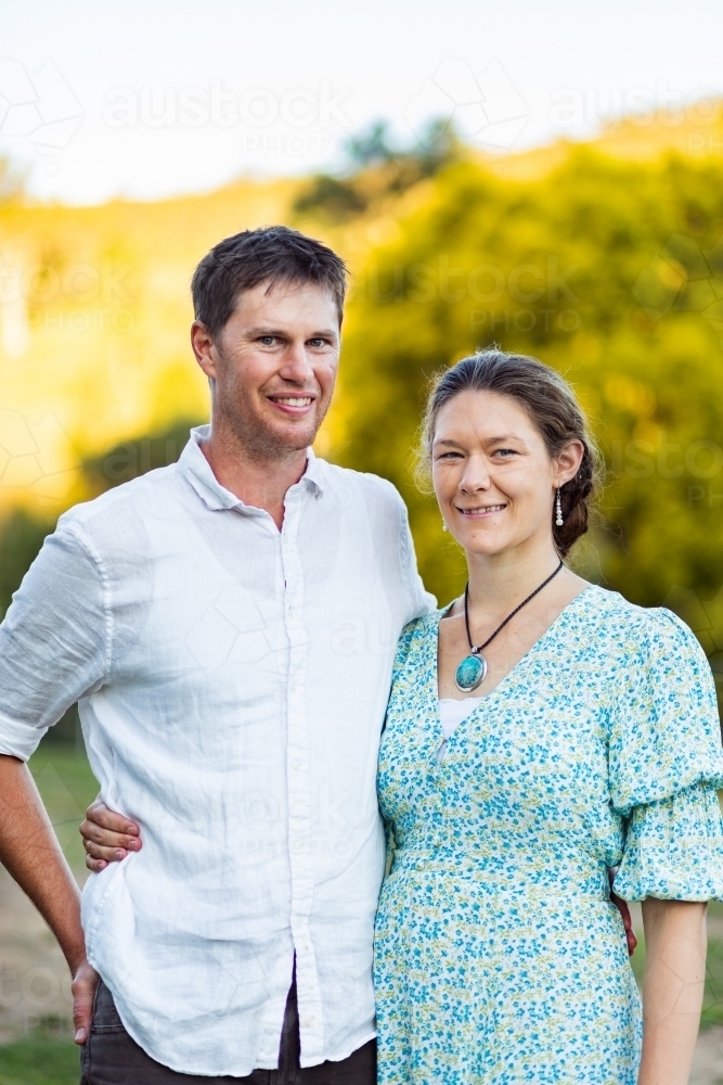 Happy couple standing together side by side - Australian Stock Image