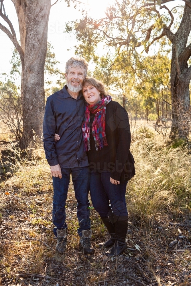 Happy couple together in paddock - Australian Stock Image