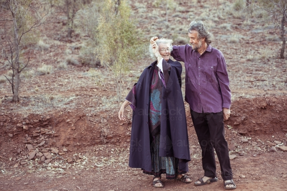 Happy elderly couple holding hands - Australian Stock Image