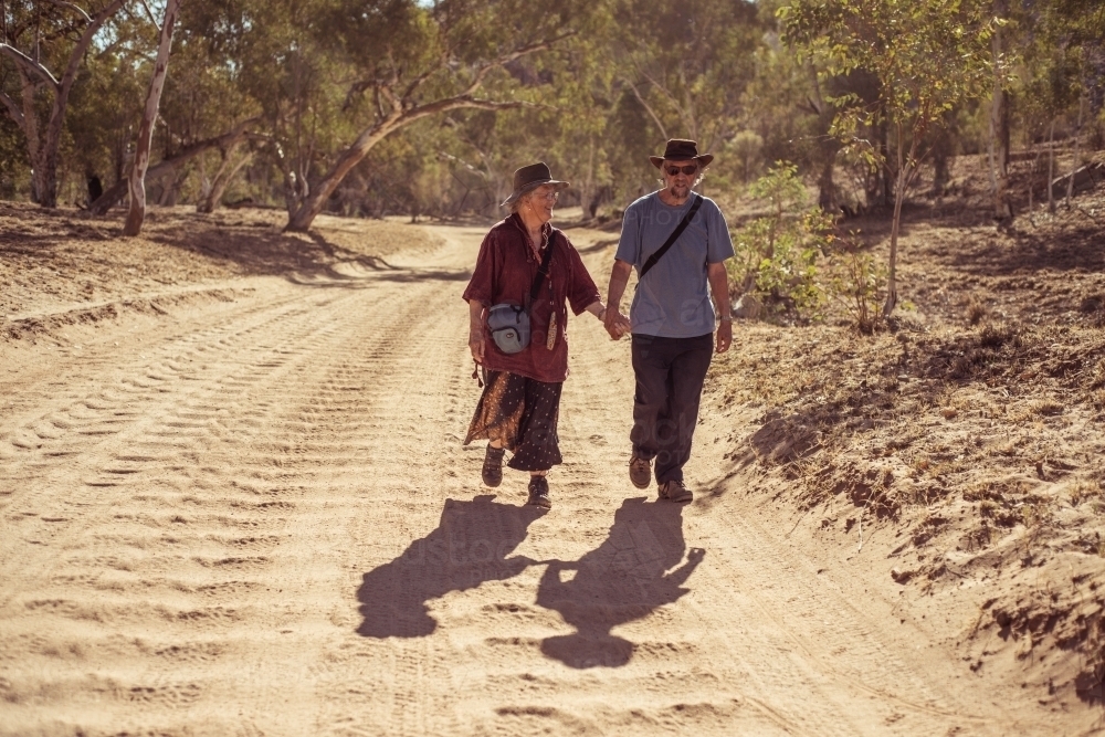 Happy elderly couple holding hands - Australian Stock Image