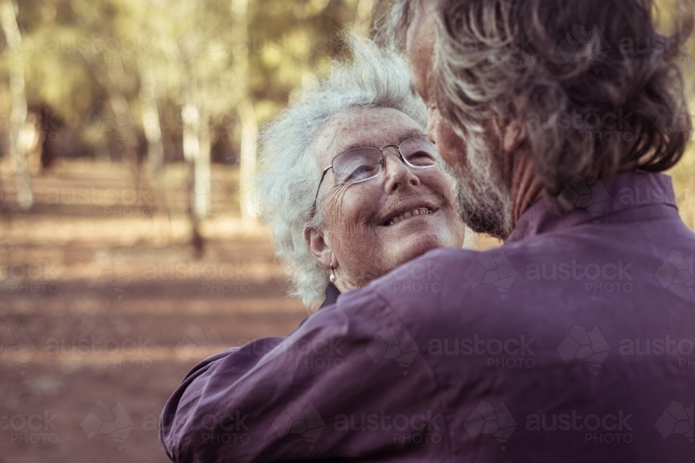 Happy elderly couple hug - Australian Stock Image