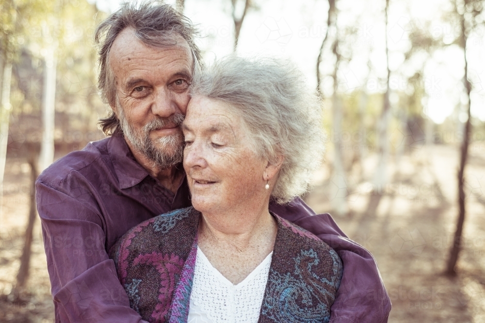 Happy elderly couple hug - Australian Stock Image