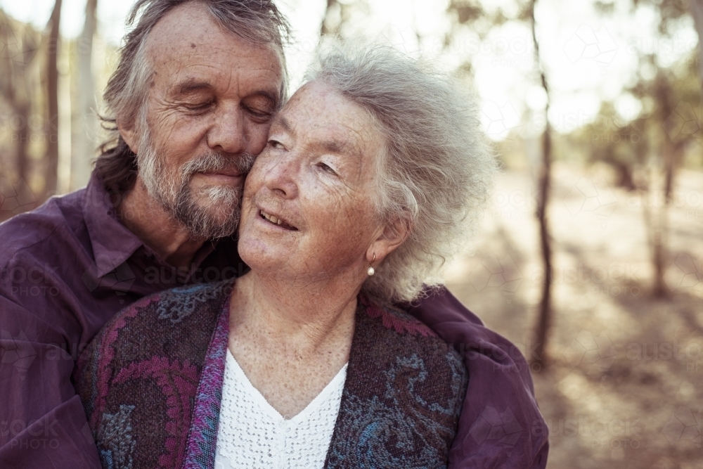 Happy elderly couple hug - Australian Stock Image