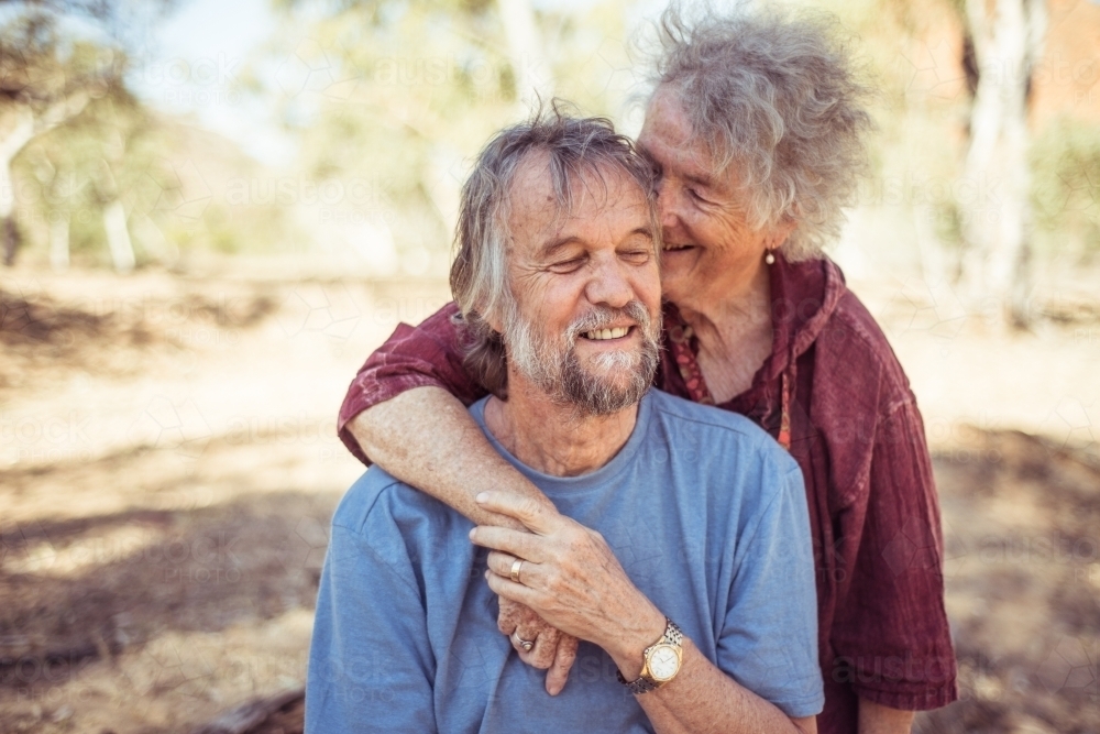 Happy elderly couple hug in the Northern Territory - Australian Stock Image