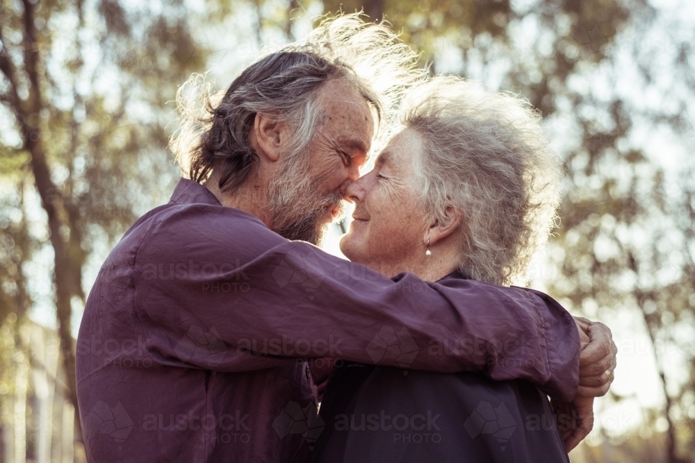 Happy elderly couple kiss in the Northern Territory - Australian Stock Image