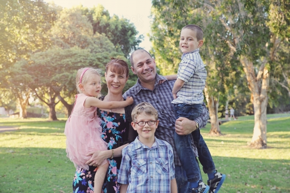 Happy family of five in the park - Australian Stock Image