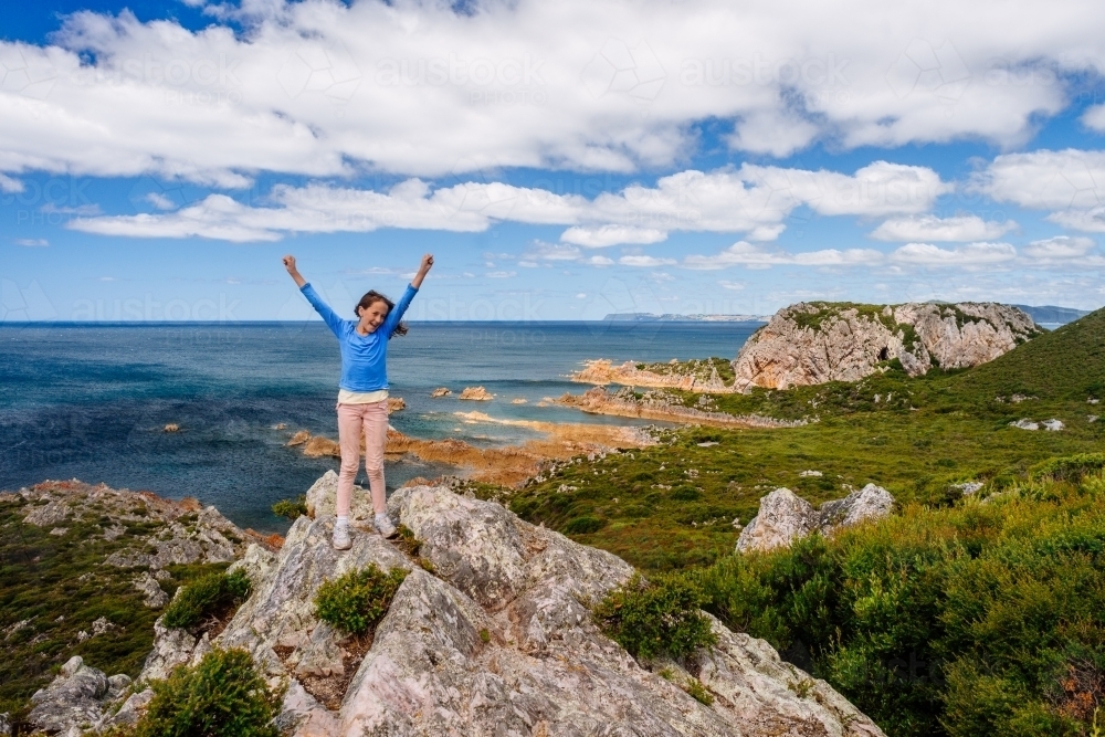 happy girl at end of hiking trail, Tasmania - Australian Stock Image