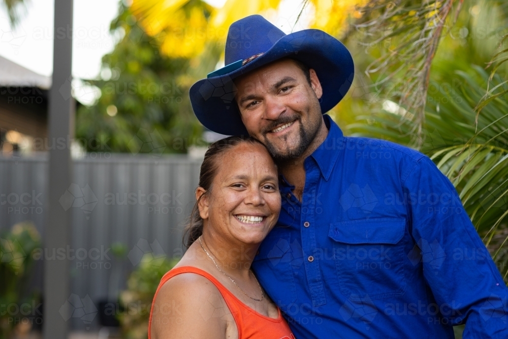 happy indigenous couple in their back yard. - Australian Stock Image
