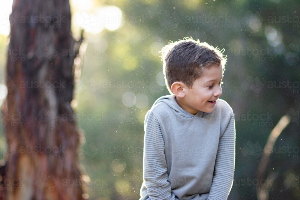 Happy little boy laughing outside - Australian Stock Image