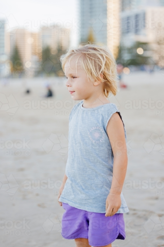 Happy little boy standing on the beach at the Gold Coast - Australian Stock Image