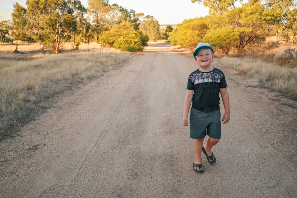 Happy little boy walking along bush track on Summer adventure - Australian Stock Image