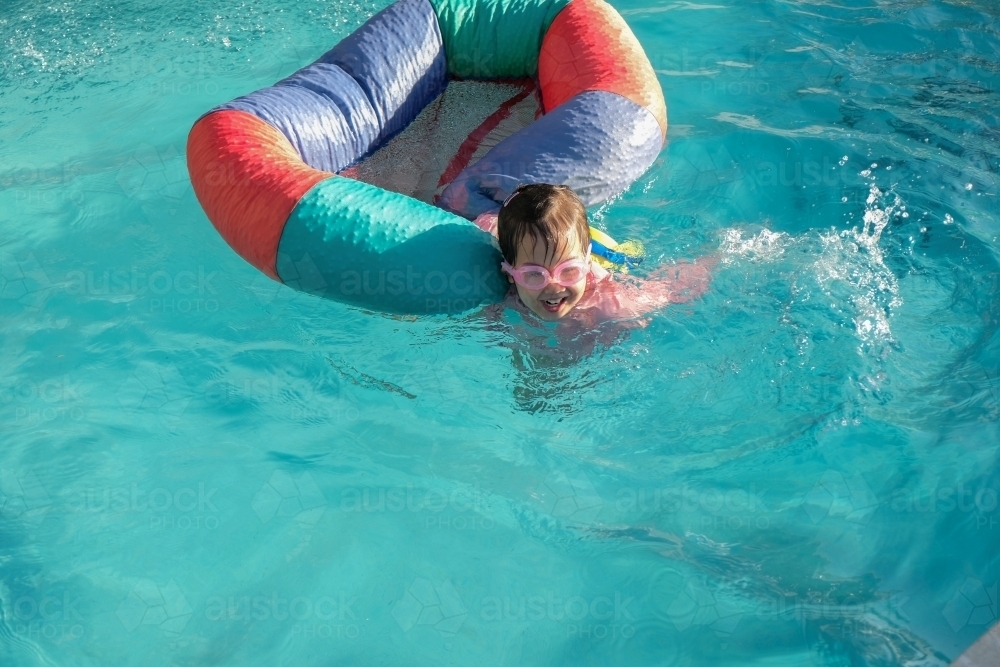 Happy little girl playing in the pool : Austockphoto Happy little girl playing in the pool - Australian Stock Image