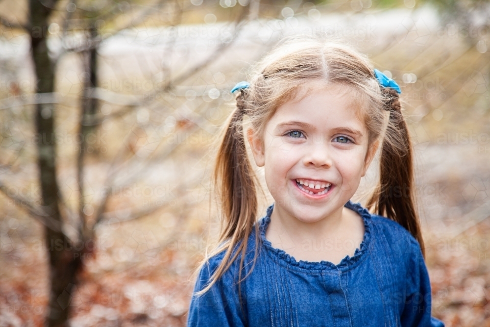 Happy little girl with gap in teeth from first lost tooth - Australian Stock Image