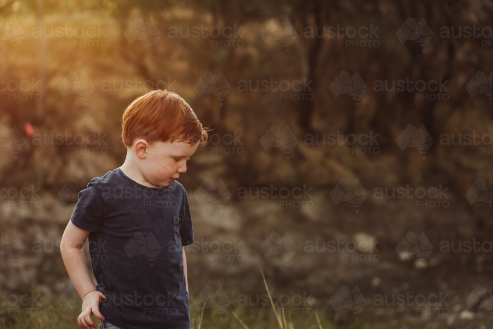Happy little red head boy exploring the Australian bush - Australian Stock Image