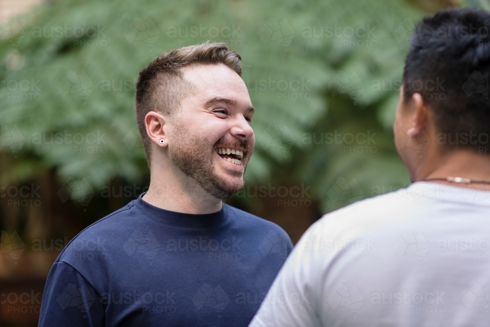 Happy man chatting to his boyfriend - Australian Stock Image