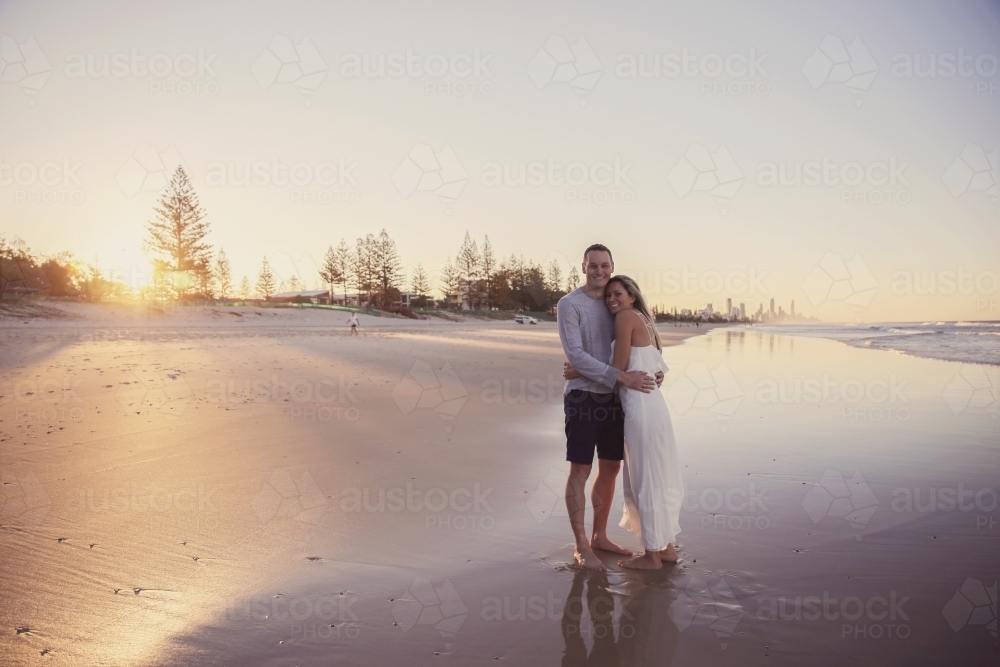 Happy mature couple on the beach at sunset : Austockphoto Happy mature couple on the beach at sunset - Australian Stock Image