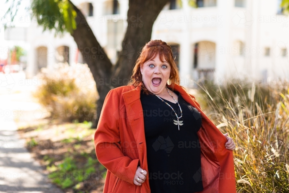 Happy middle age woman with look of delight or shock on face - Australian Stock Image