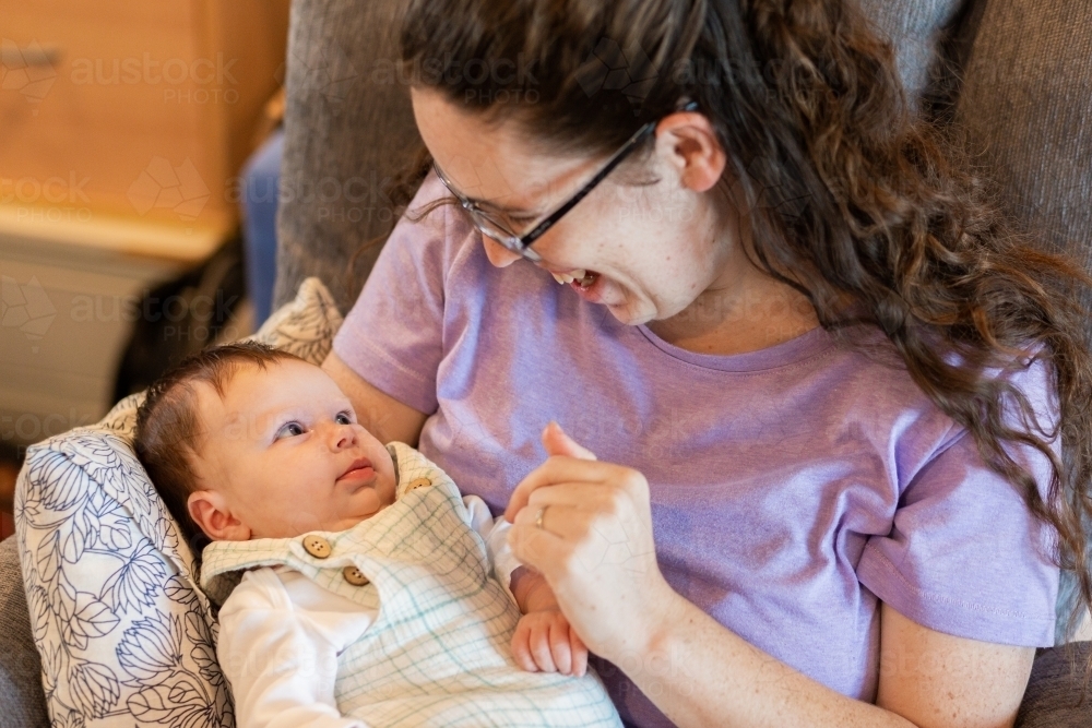 Happy mother and baby looking at each other in home - Australian Stock Image