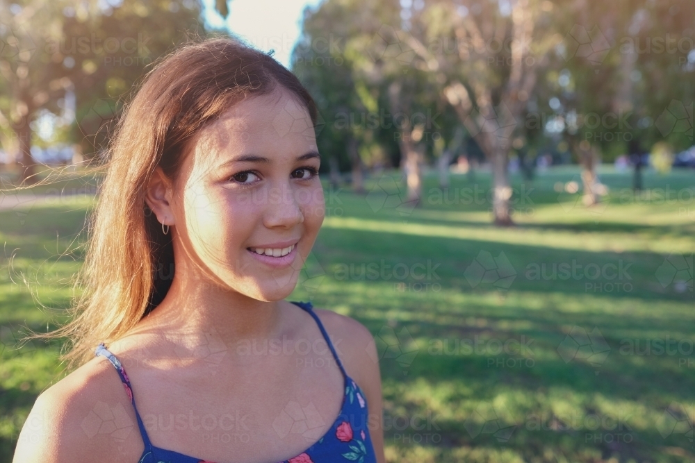 Happy multi ethnic teenage girl in the park - Australian Stock Image