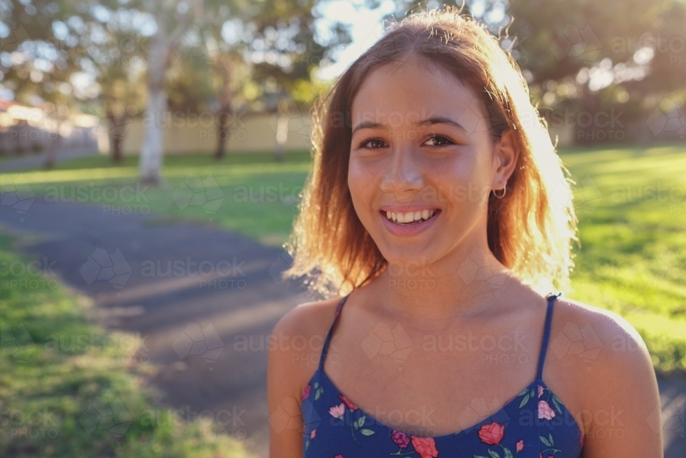 Happy multi ethnic teenage girl in the park - Australian Stock Image