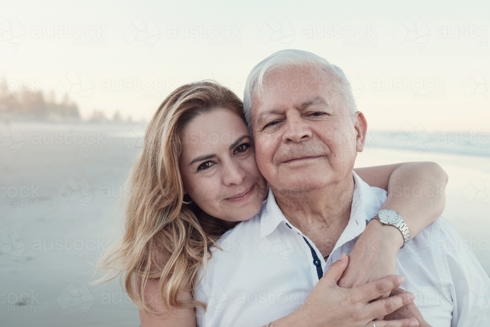 happy multicultural daughter and father on the beach - Australian Stock Image