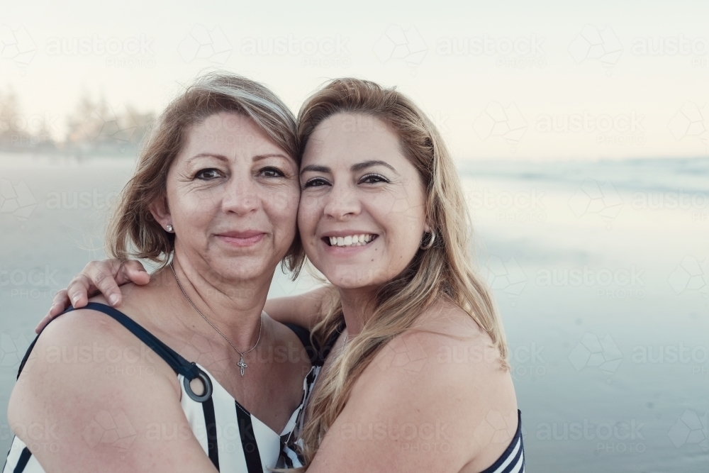 happy multicultural daughter and mother on the beach - Australian Stock Image