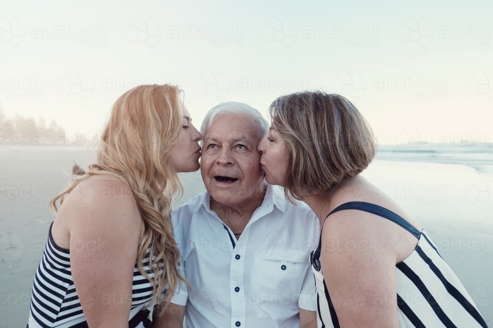 happy multicultural daughter and parents on the beach - Australian Stock Image