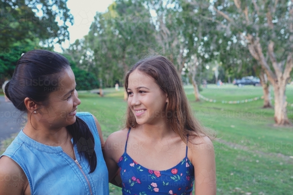 Happy multicultural mother and daughter in the park - Australian Stock Image