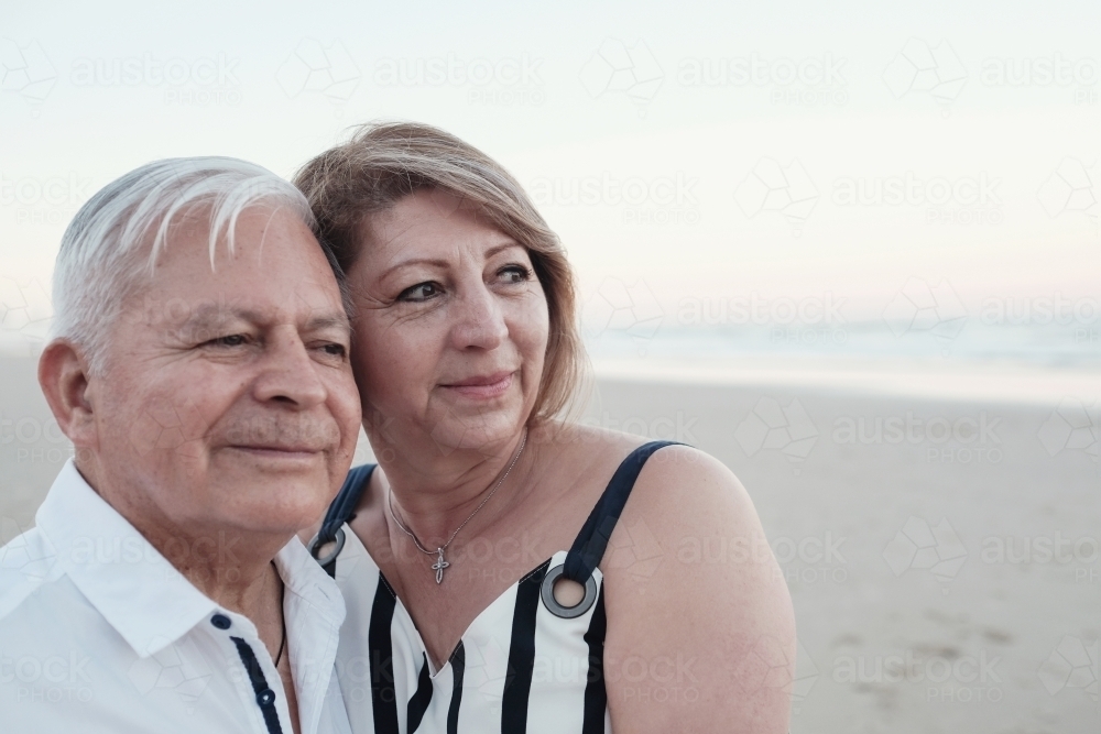 Happy multicultural senior couple on the beach - Australian Stock Image