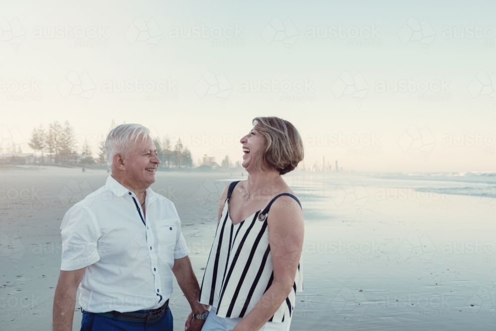 Happy multicultural senior couple on the beach - Australian Stock Image