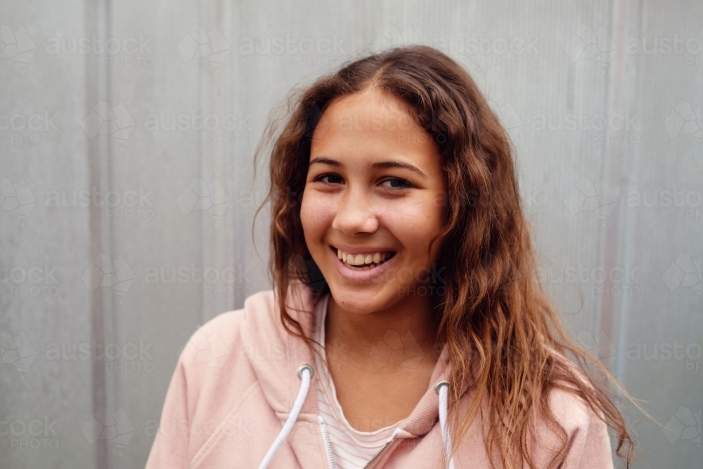 Happy multicultural teen girl with long hair - Australian Stock Image