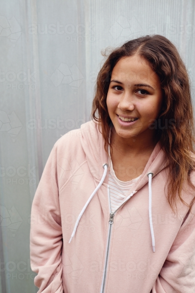 Happy multicultural teen girl with long hair - Australian Stock Image