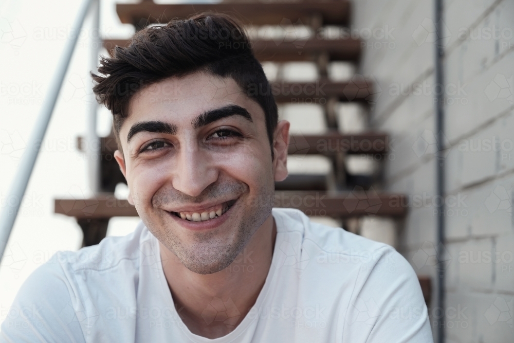 Happy multicultural young adult man, university student - Australian Stock Image