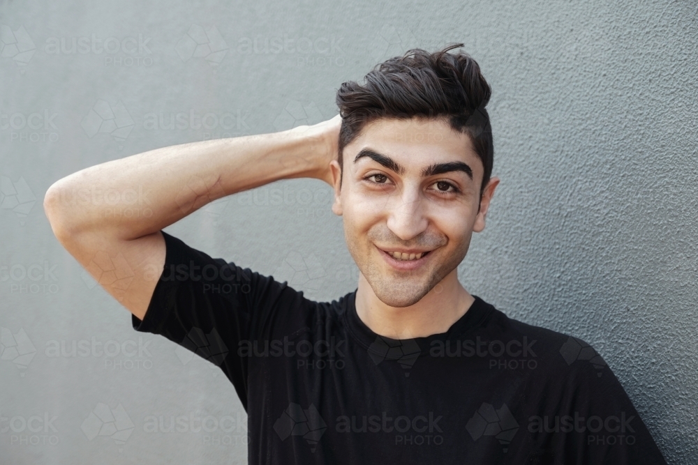 Happy multicultural young adult man, university student - Australian Stock Image