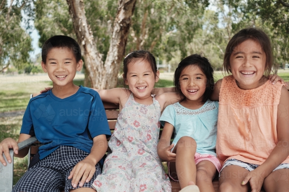 Happy multicultural young children at park - Australian Stock Image