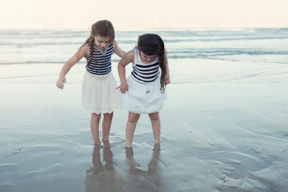 Happy multicultural young little girls on the beach - Australian Stock Image