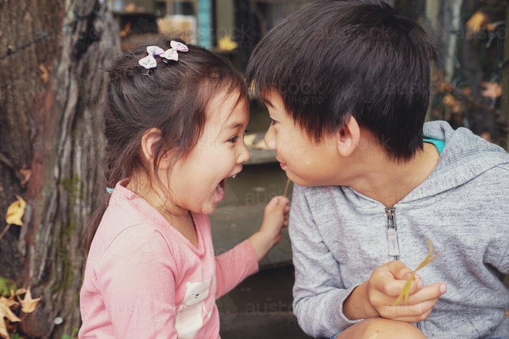 Happy multiethnic brother and sister - Australian Stock Image