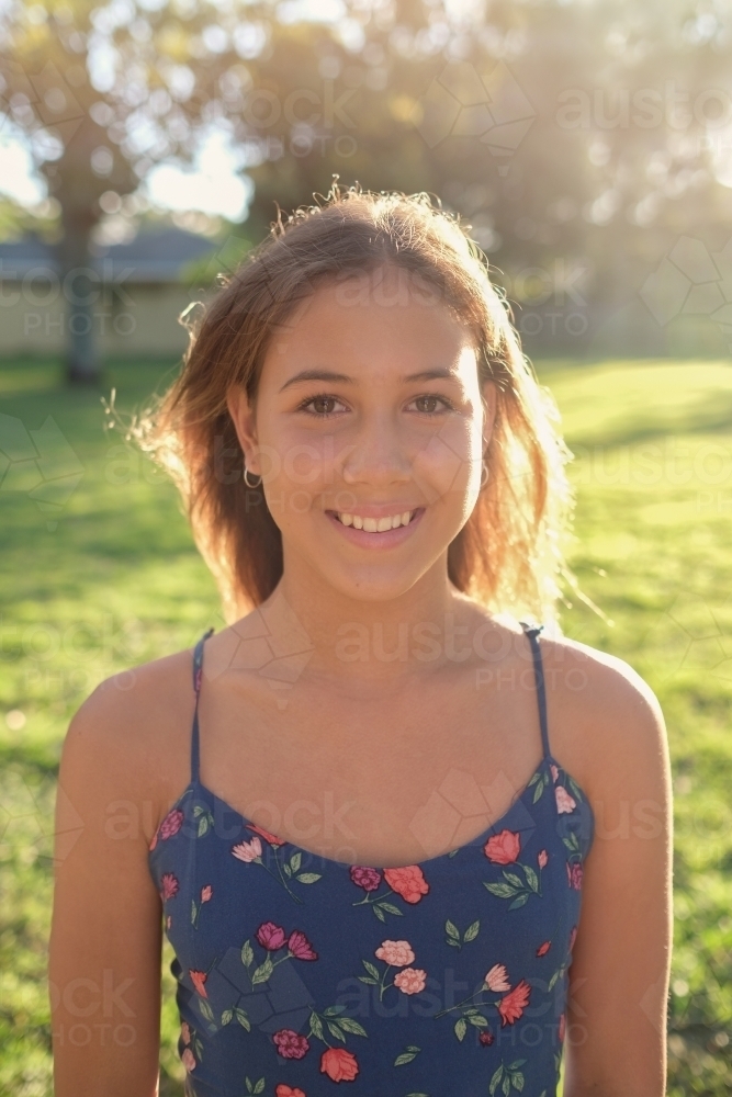 Happy multiethnic teenage girl in the park - Australian Stock Image