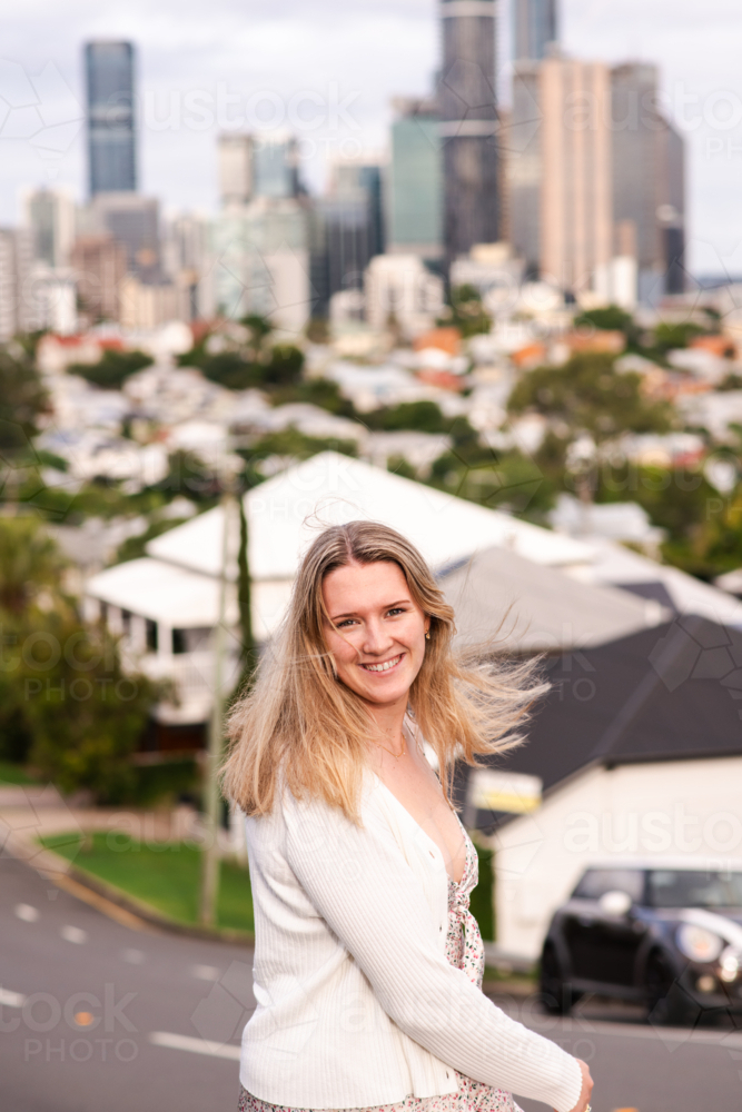 happy natural 24 year old woman on a suburban street - Australian Stock Image