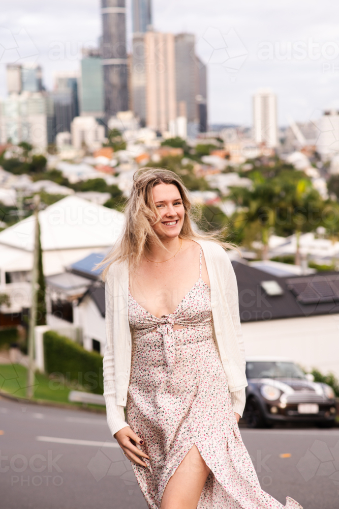 happy natural 24 year old woman on a suburban street - Australian Stock Image