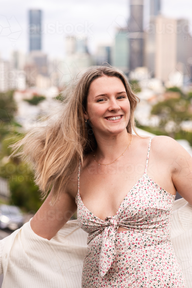 happy natural 24 year old woman on a suburban street - Australian Stock Image