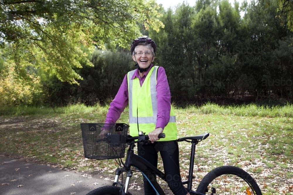 Happy older lady with bike - Australian Stock Image