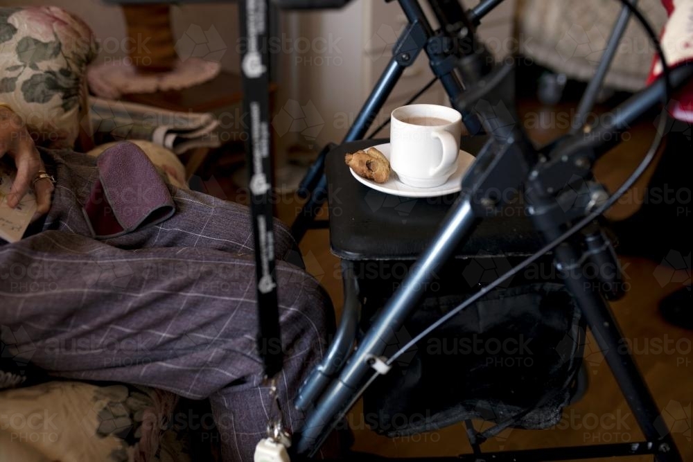 Happy retirement village resident sitting in an arm chair - Australian Stock Image