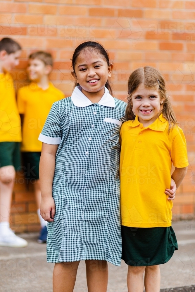 Happy school friends with different ethnicities smiling together happy to be back to school - Australian Stock Image