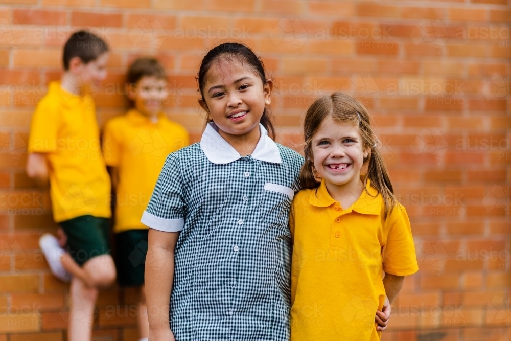 Happy school friends with different ethnicities smiling together happy to be back to school - Australian Stock Image