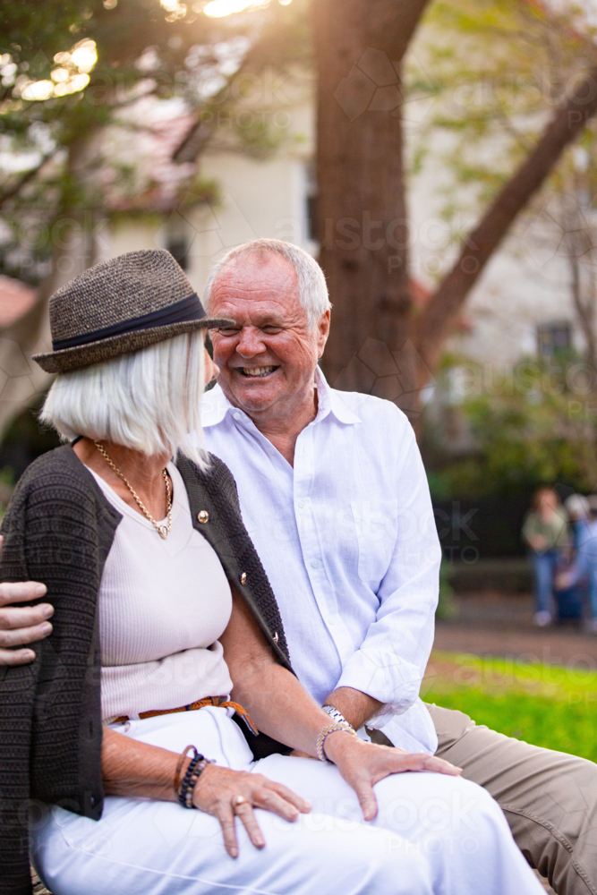 Image of Happy Senior couple sitting on park bench - Austockphoto